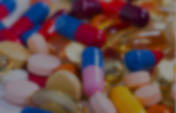 A close-up image of multiple different medication pills jumbled together